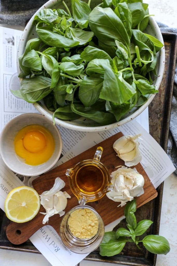 Homemade Garlic Basil Aioli ingredients on a table