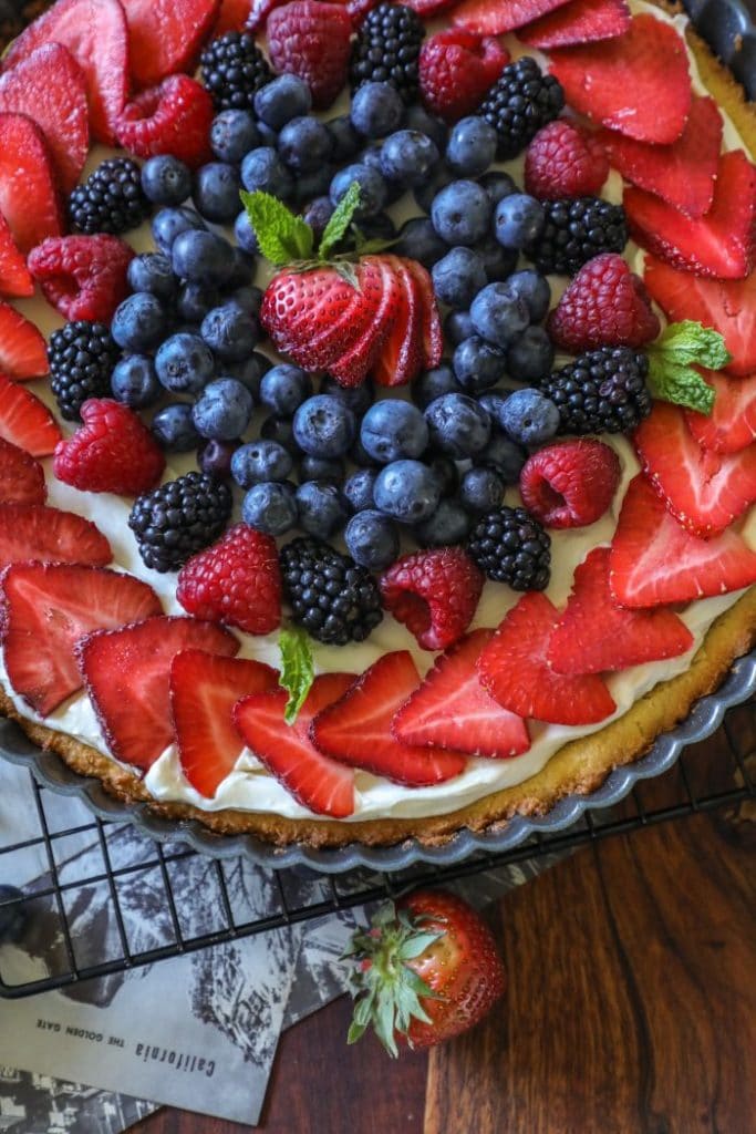 A cookie with fruit on top of a table