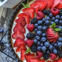 Large keto sugar cookie with decorated fruit on top.