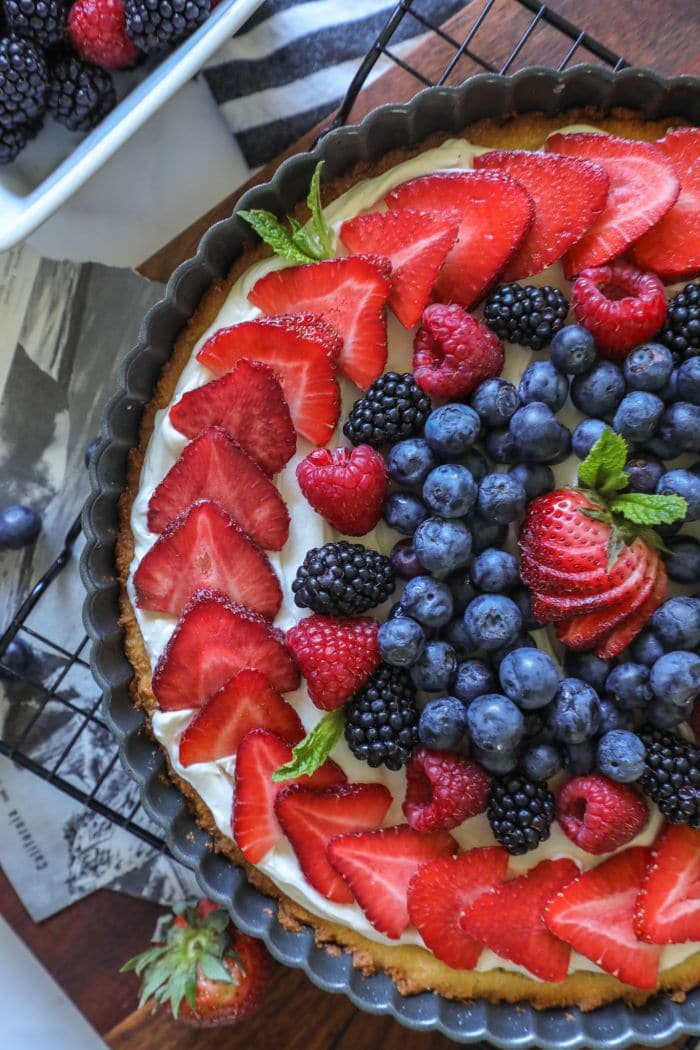 Large keto sugar cookie with decorated fruit on top.