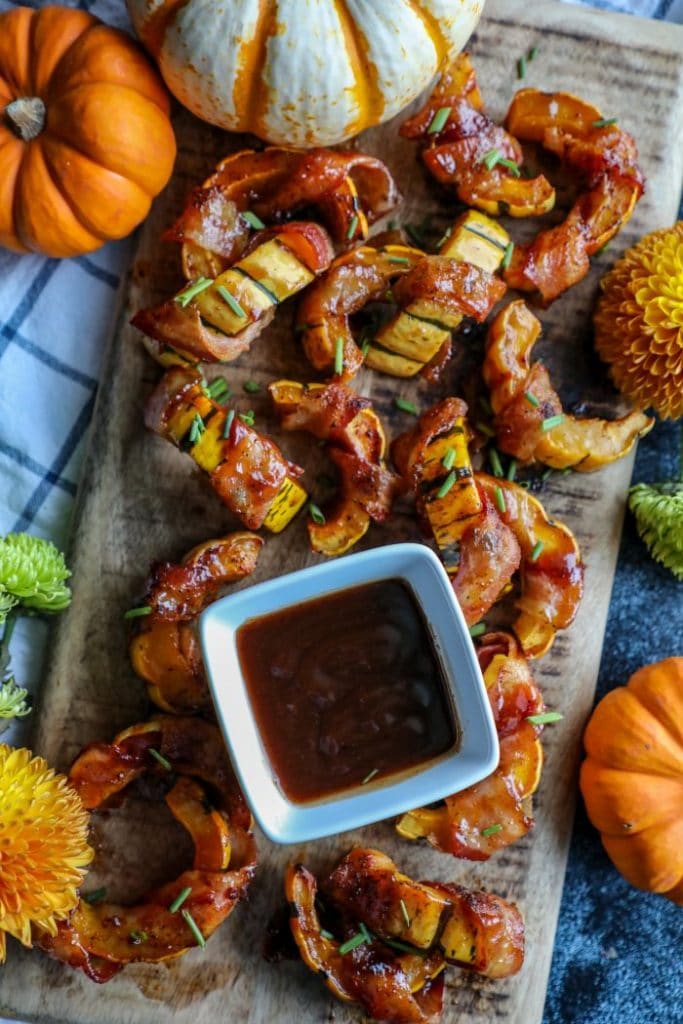 Low Carb BBQ Bacon Wrapped Delicata Squash on a cutting board