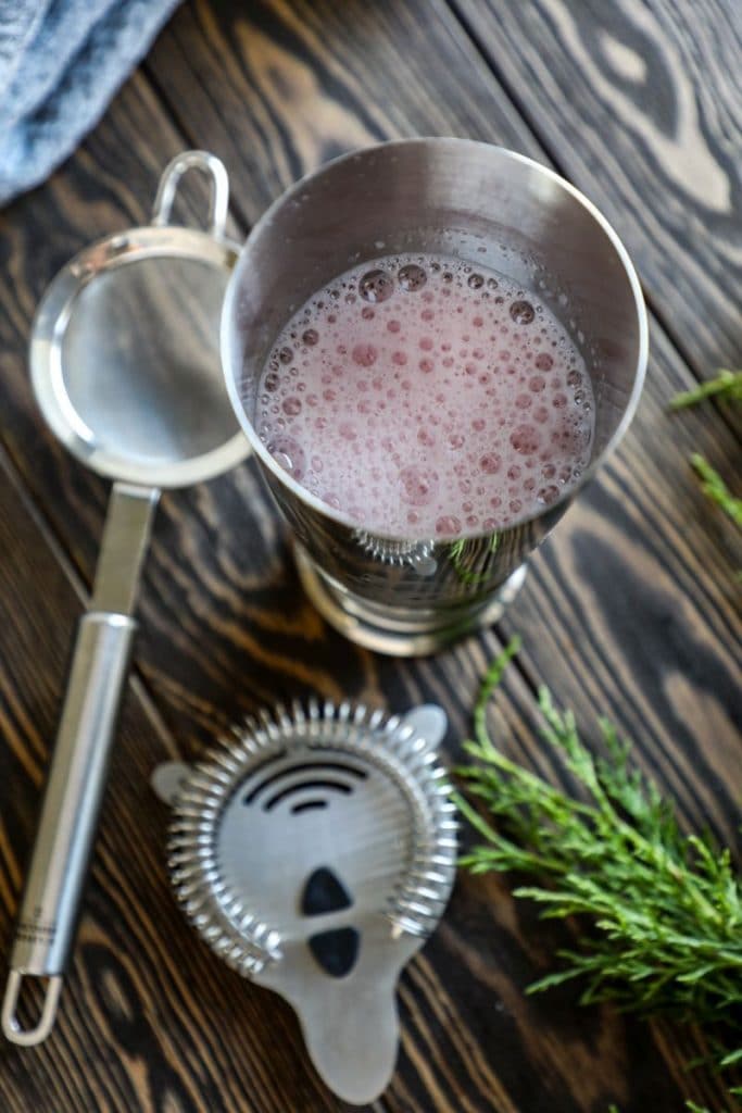 Cranberry pisco sour shaken into a foam