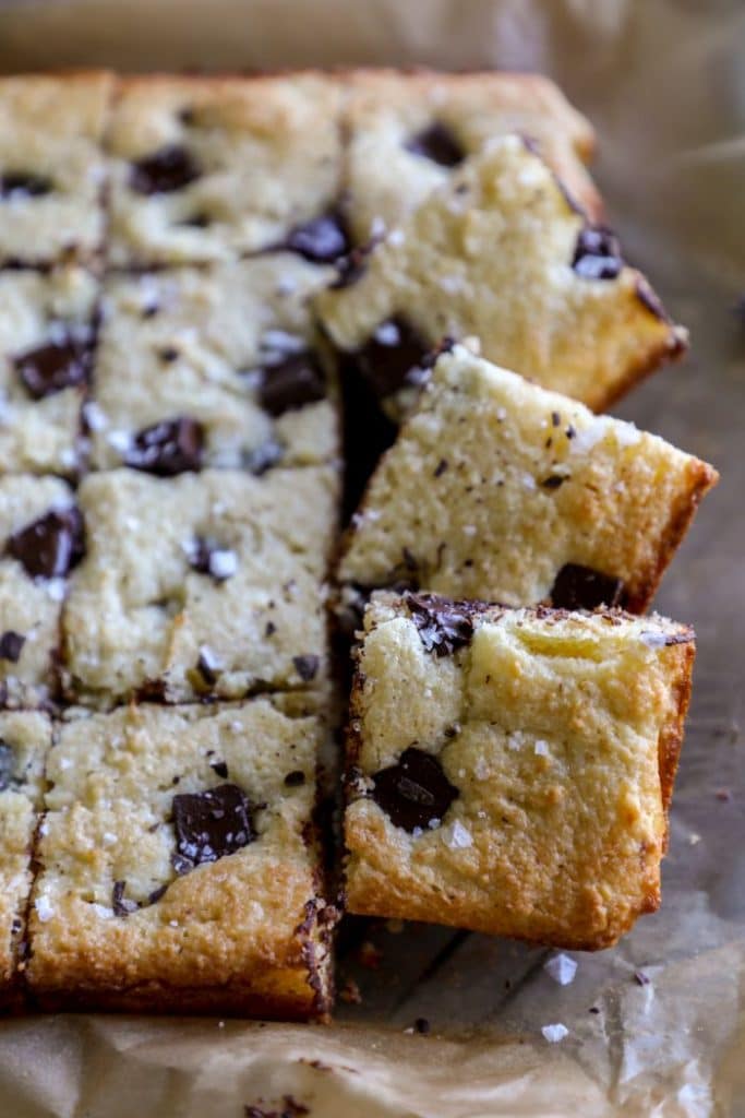 Keto blondies stacked on parchment paper 