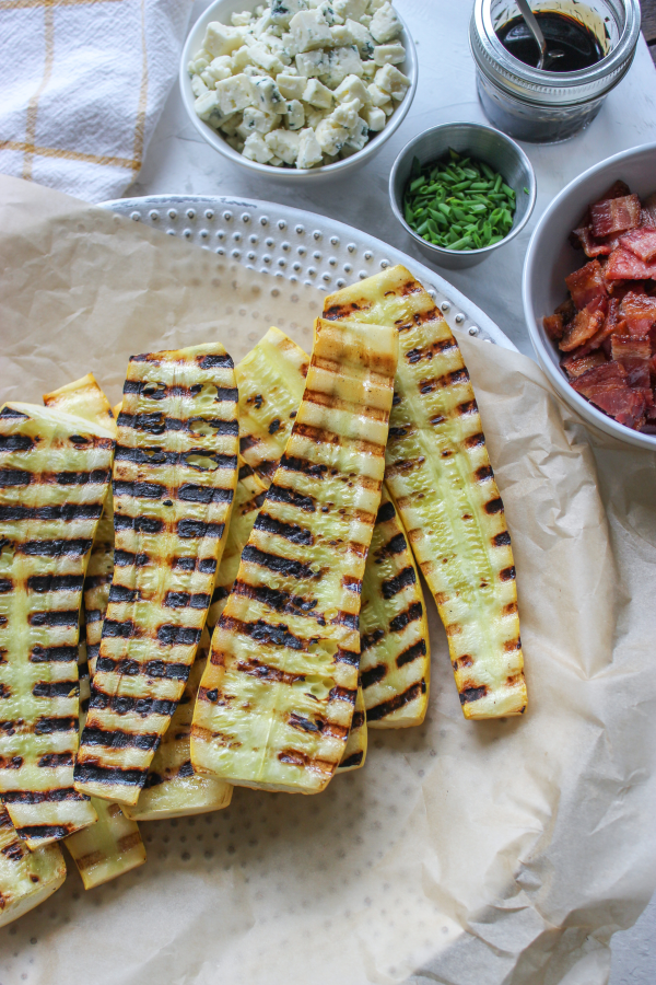 A table topped with different types of food, with Squash and Bacon