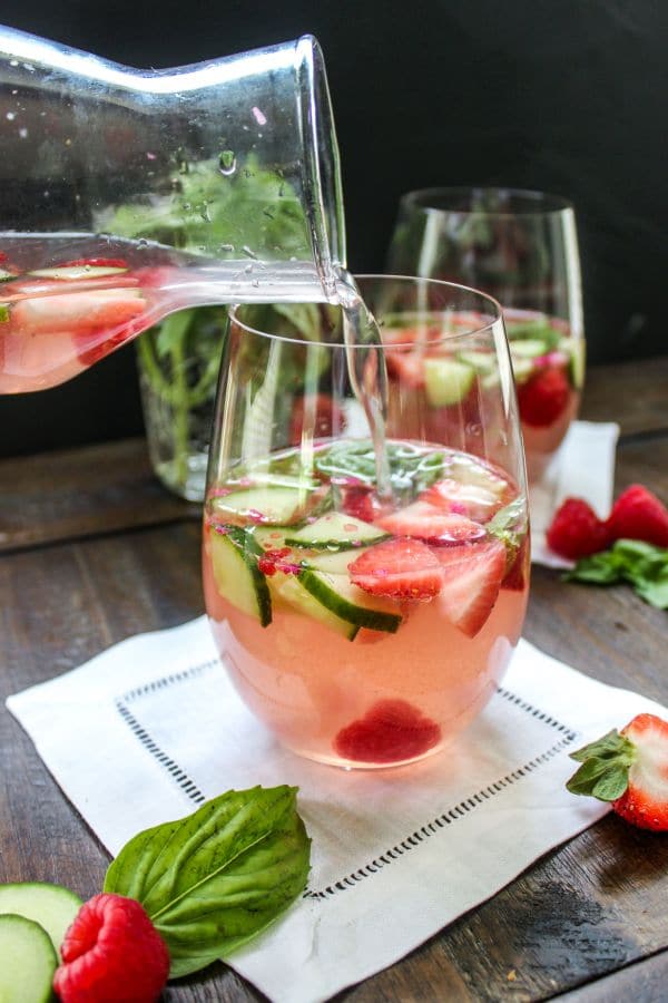 Berry Basil Rose Sangria being poured into a glass.