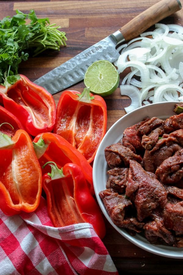 Carne asada fire roasted stuffed pepper ingredients prepped on a cutting board. 