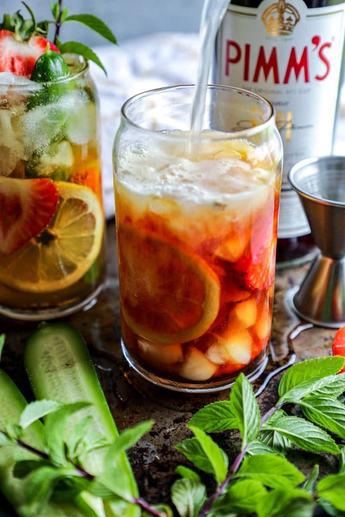 Pouring ginger beer into a low carb pimms cup