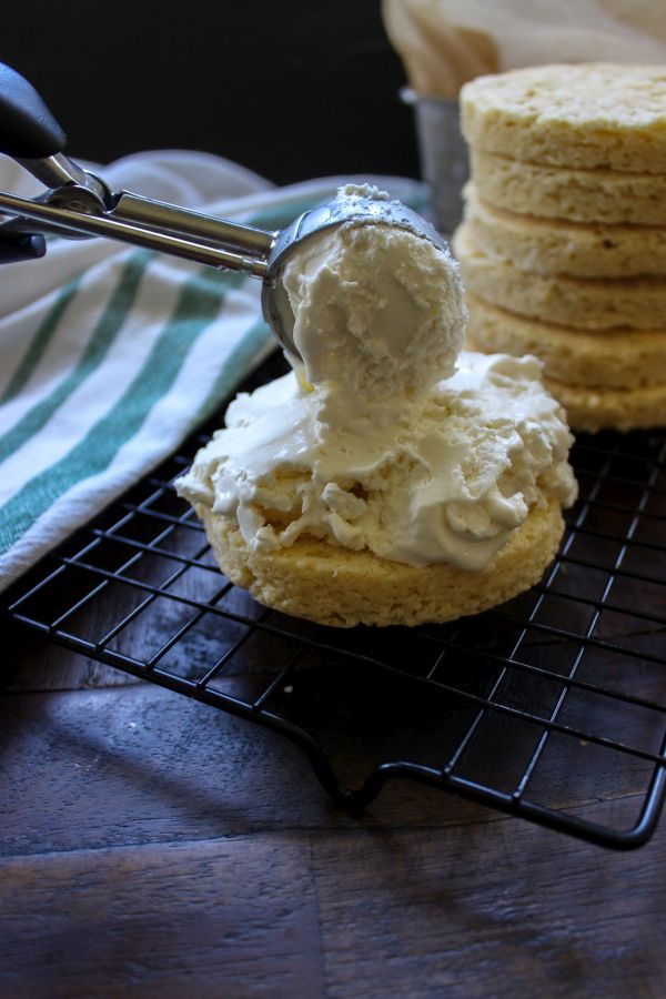 A piece of cake sitting on top of a table with ice cream on it. 