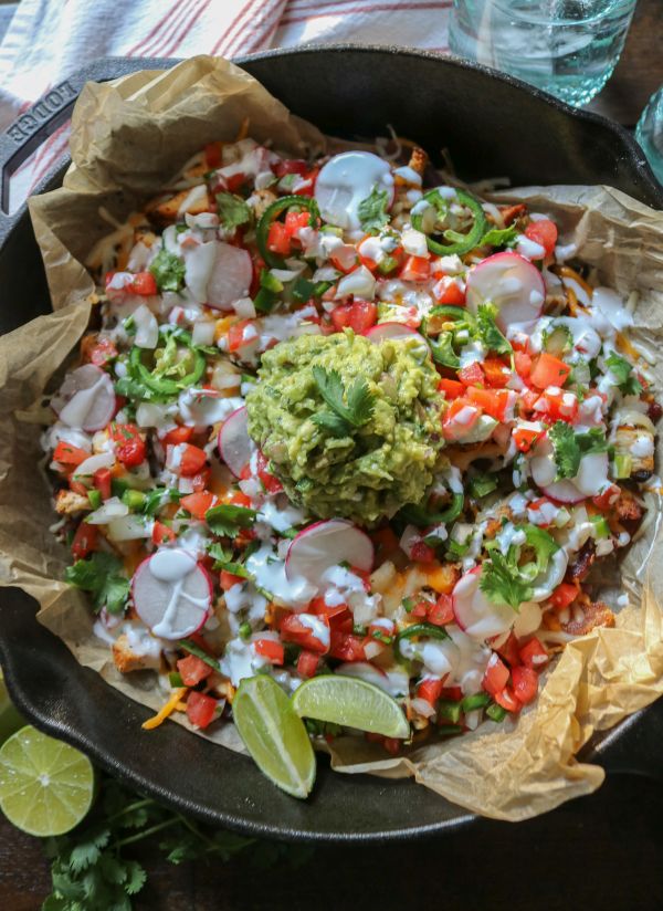 Nachos just got a delicious keto upgrade with these easy to make bacon chips, topped with smoked chicken, cheddar cheese, and all your favorite nacho toppings! 