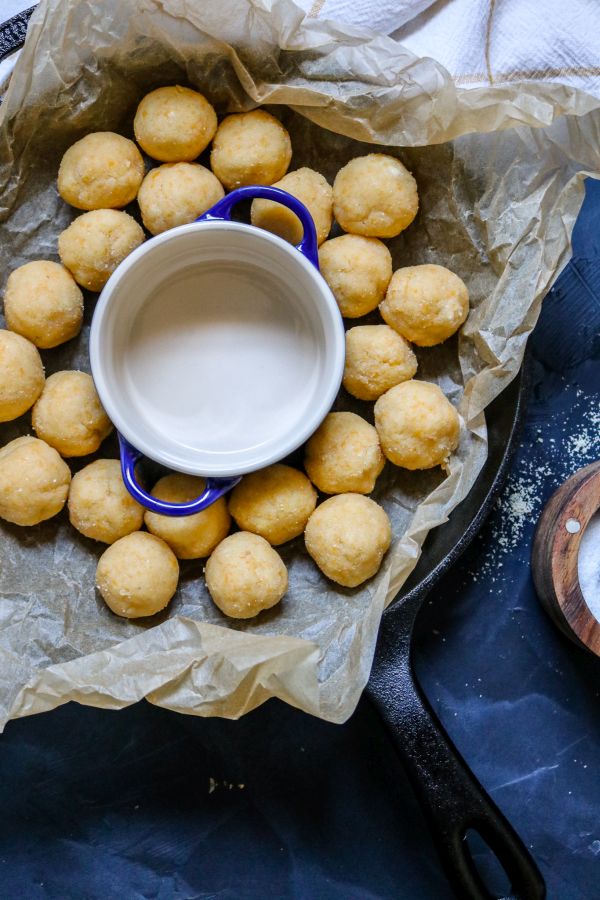 Keto cheddar biscuit dough rolled into small balls before baking