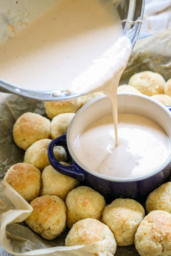 Keto low carb beer cheese sauce being poured into a small bowl for serving