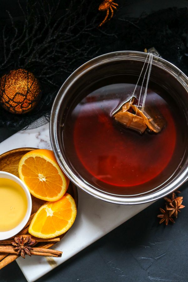 brewed chai tea with cinnamon and oranges