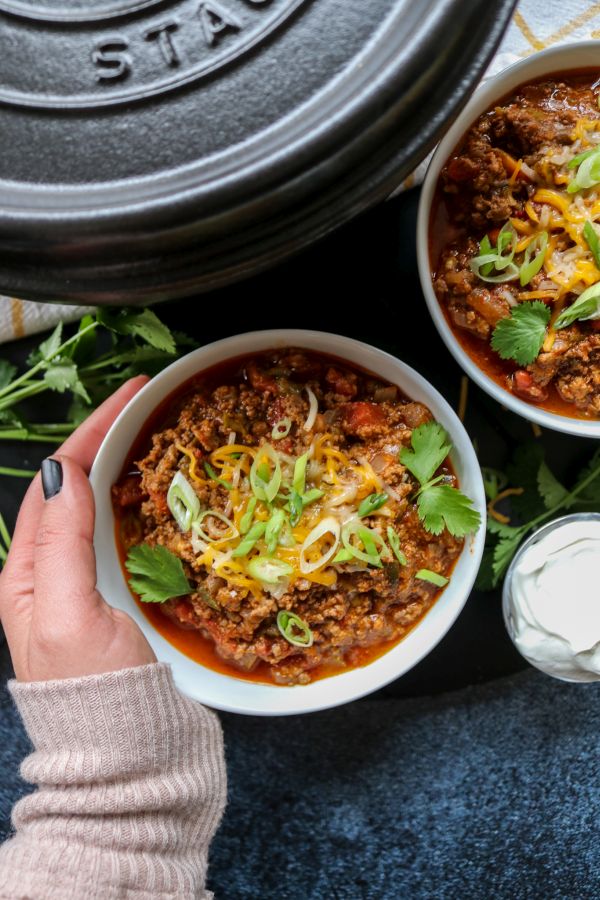 Hand holding low carb beef chili