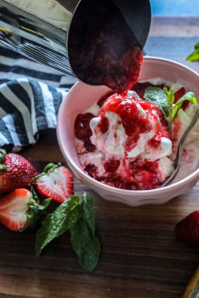 A bowl of ice cream with smoked Strawberry sauce