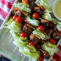 Close up of burger kebabs on a tray.