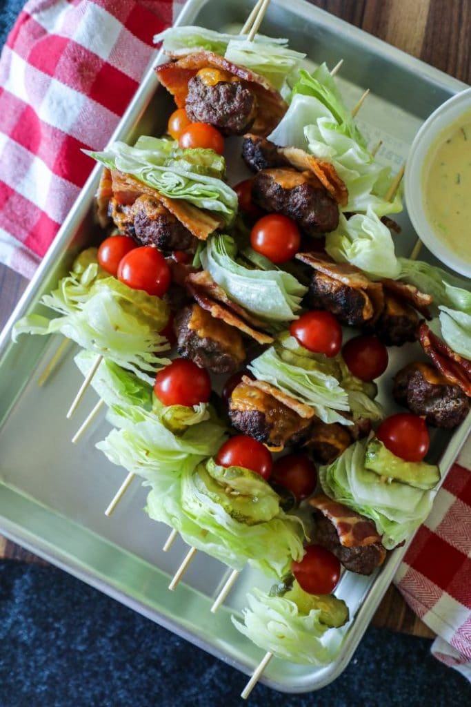 Close up of burger kebabs on a tray.
