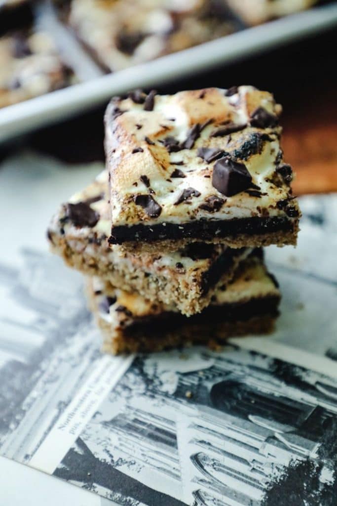 Close up of three stacked keto smores bars over a newspaper
