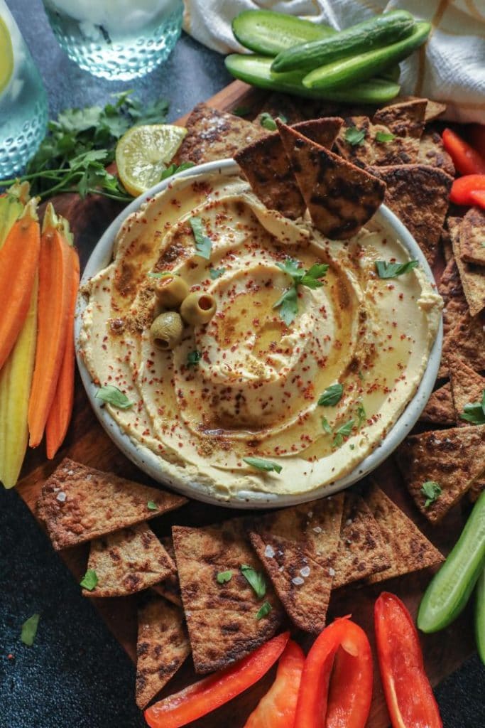 A plate of food with keto pita chips and hummus. 