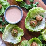 A bunch of food on a table, with Meatball and Egg roll