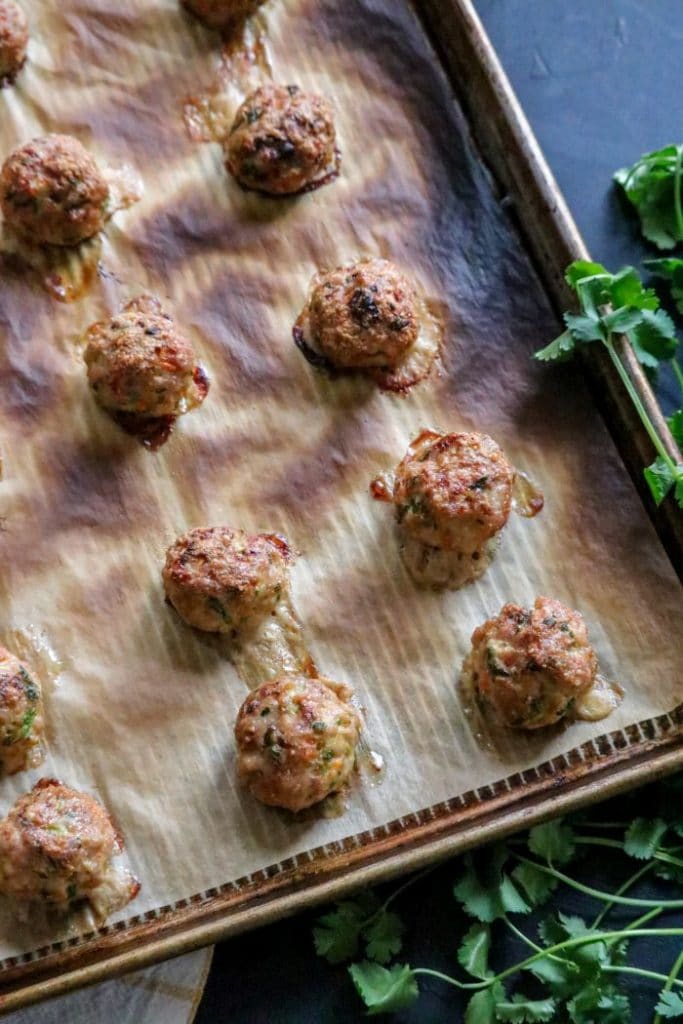 Baked egg roll meatballs on a sheet pan.