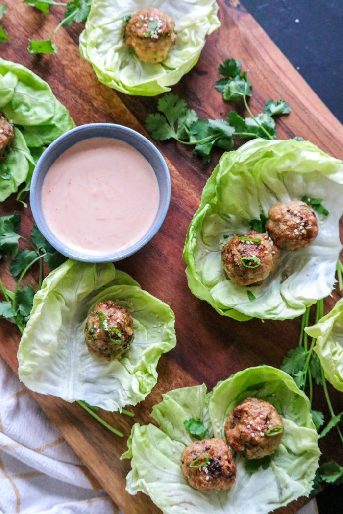 A bunch of food on a table, with Meatball and Egg roll