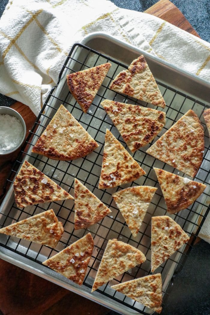 Keto Pita Chips on a baking sheet with a white towel