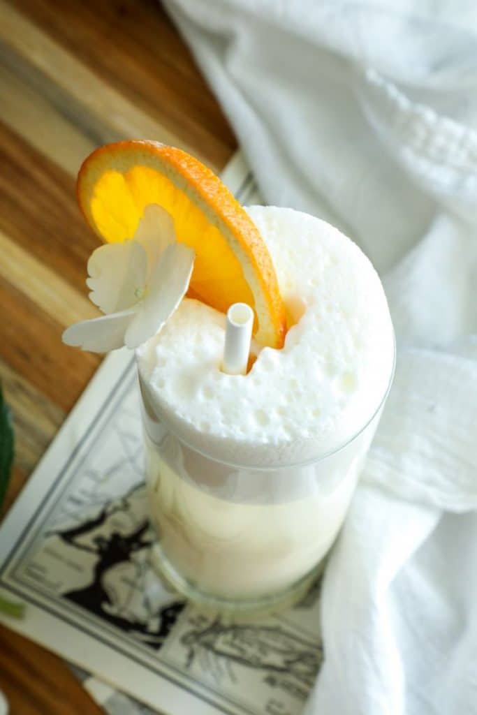 Close up on the keto creamsicle cocktail to view the egg white foam top. 