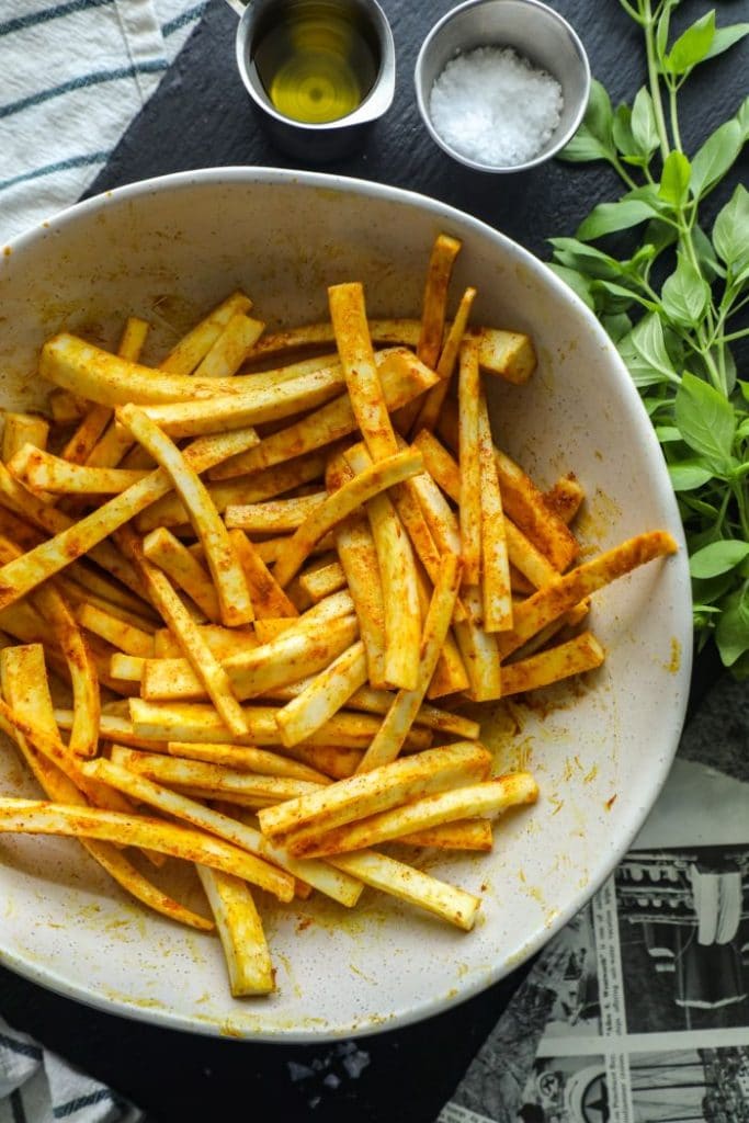 Seasoned keto jicama fries in a white bowl.