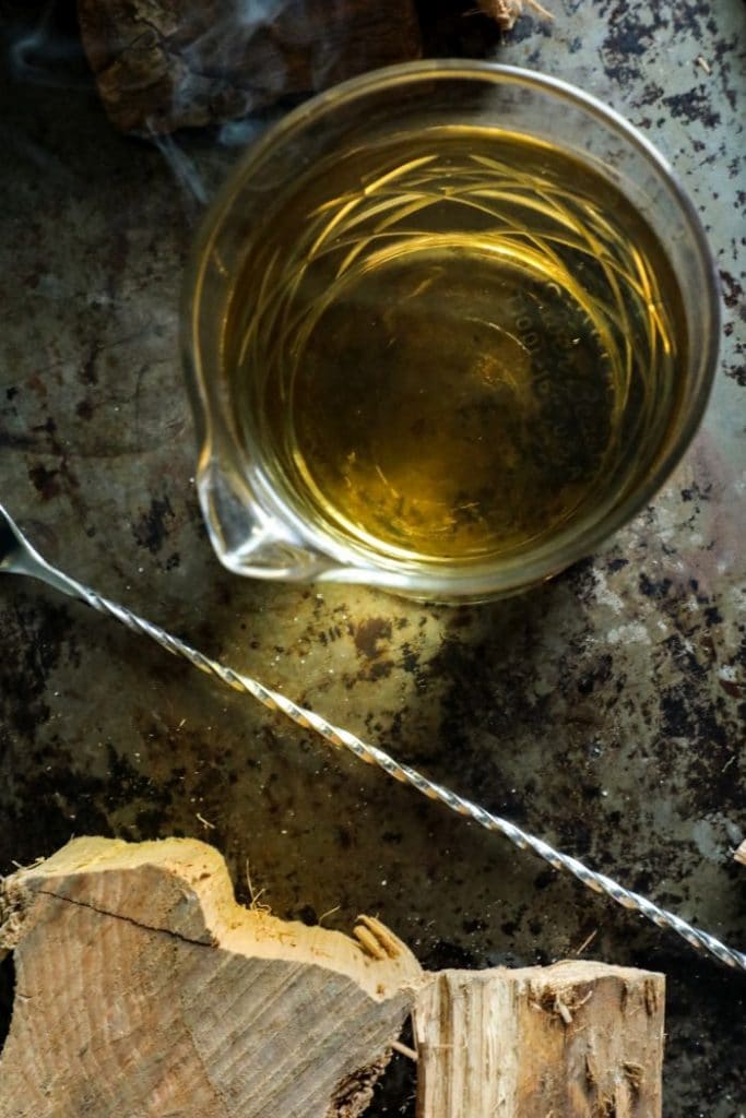 Smoke Infuse Simple Syrup - Overhead shot on a tray with a bar spoon.