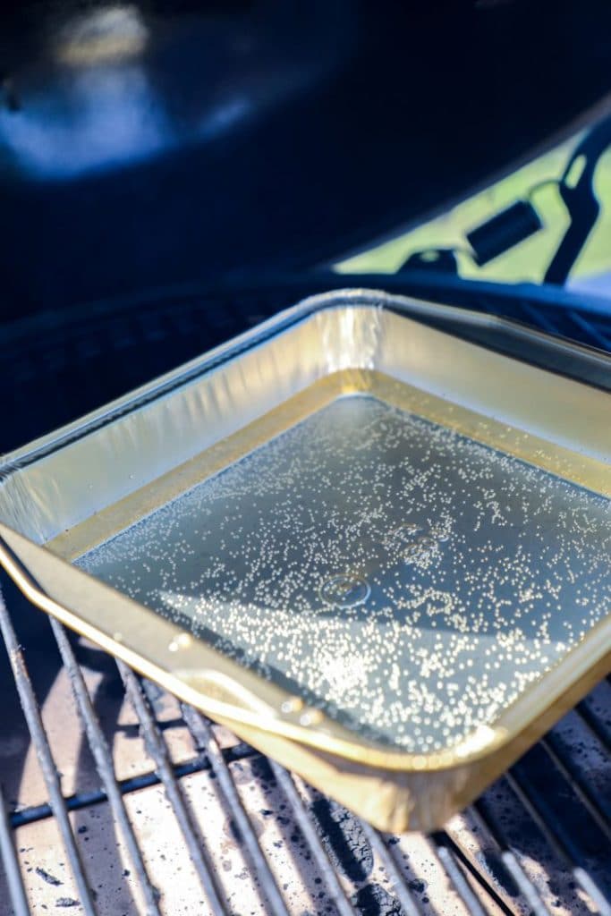 Simple syrup smoking on the grill in a foil pan.