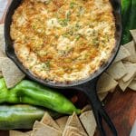 Smoked Hatch Chili Pepper Dip in a cast iron pan with keto tortilla chips