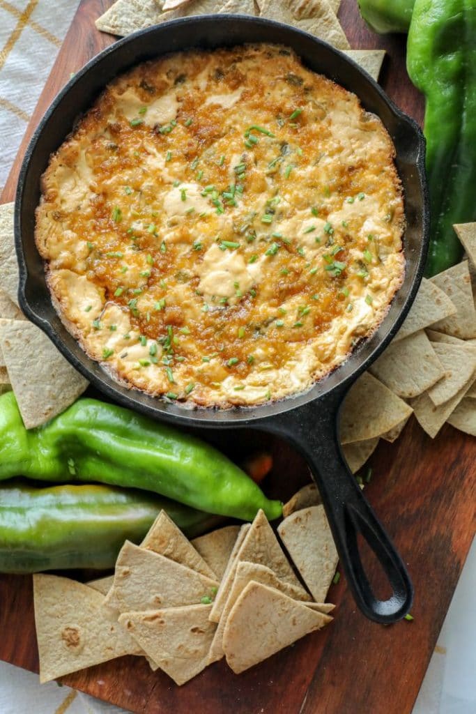 Smoked Hatch Chili Pepper Dip in a cast iron pan with keto tortilla chips