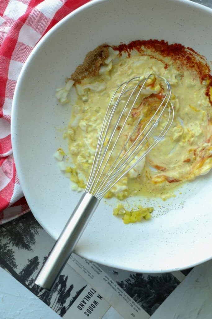 A bowl with a whisk, mixing the keto burger sauce ingredients together.