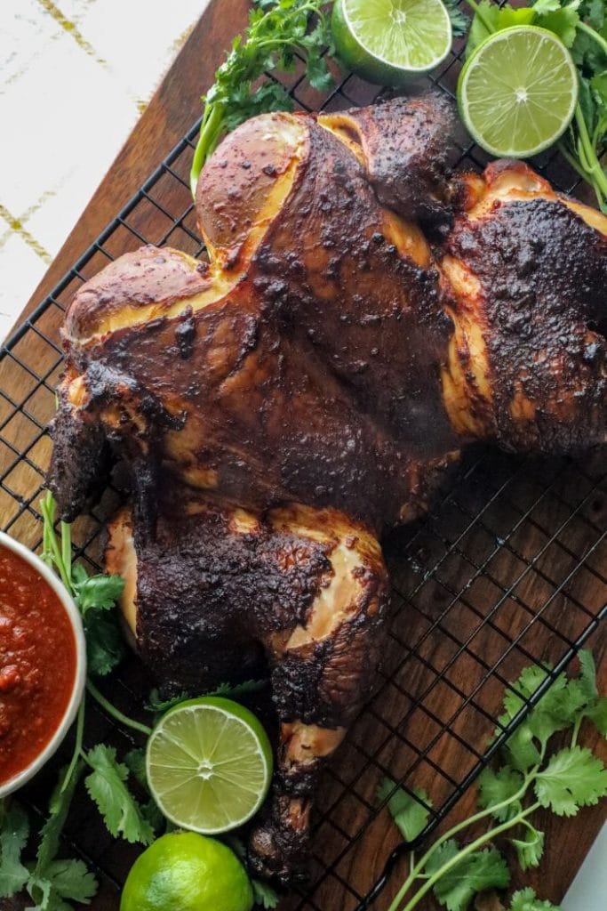 Grilled Spatchcock Chicken Tinga on a cutting board