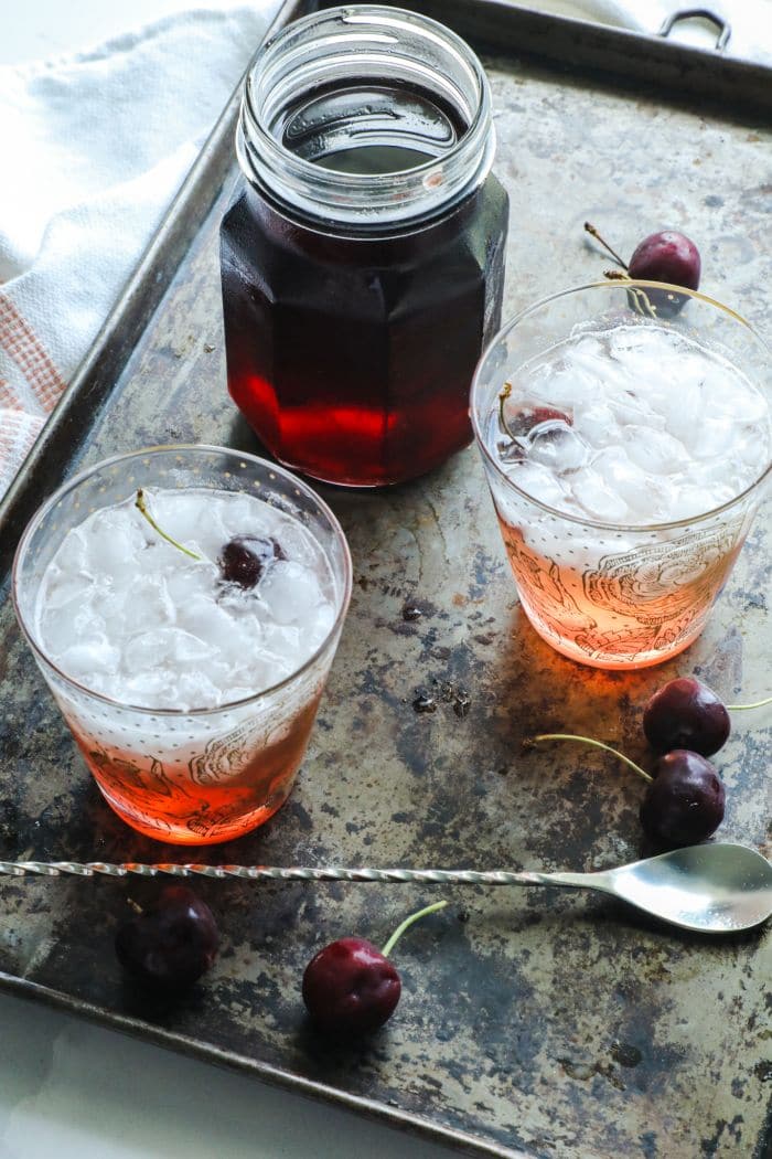 Keto Grenadine Cocktail Syrup with two shirley temples on a tray.