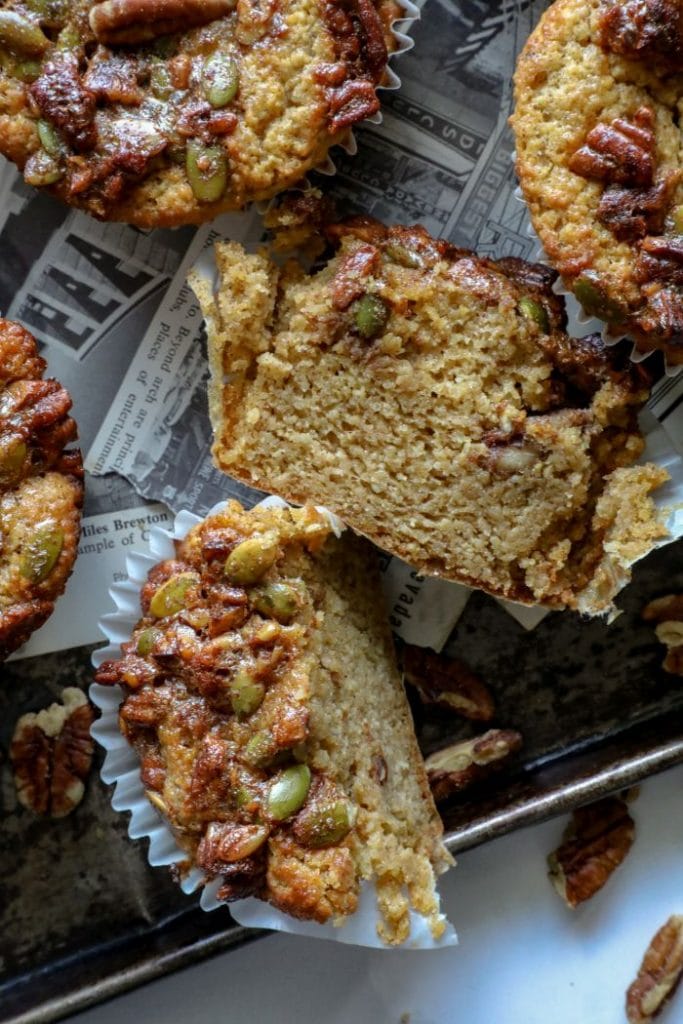 Keto pumpkin muffin cut in half on a tray.