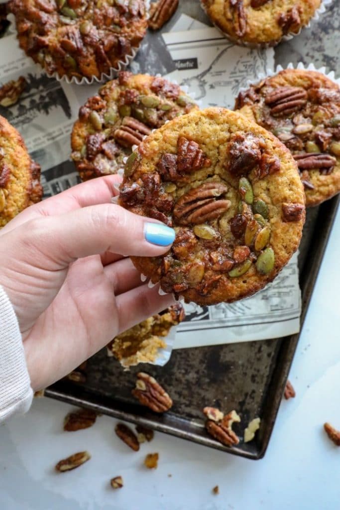 Keto Pumpkin Muffins being held by a hand.