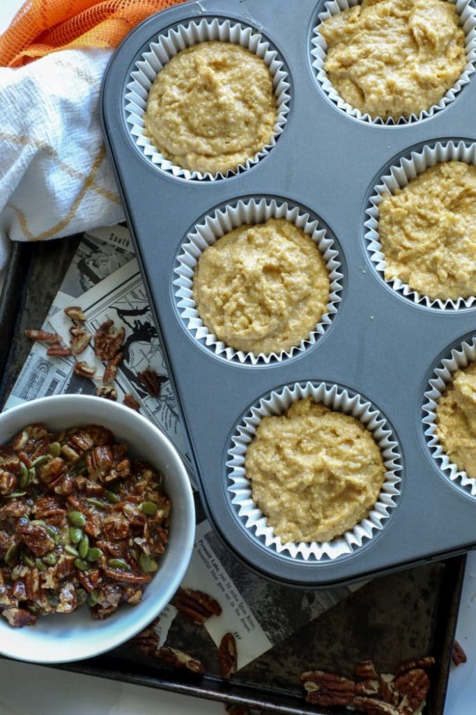 Keto pumpkin muffin batter in the muffin tin.