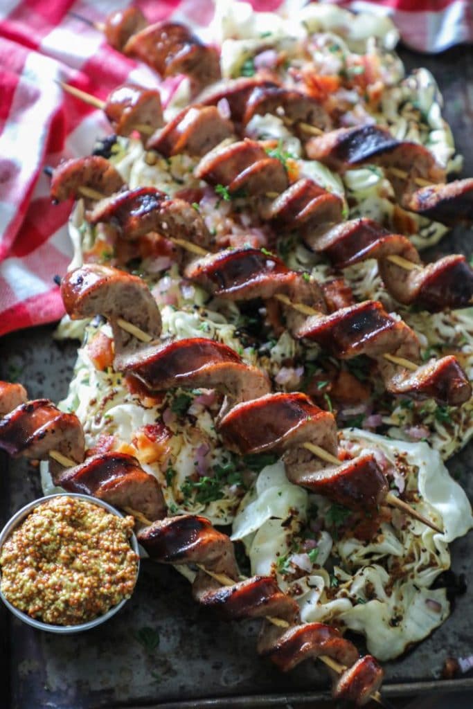 Char Grilled Cabbage Steaks and Smoked Sausage spiralized on a platter.