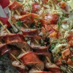 Char Grilled Cabbage Steaks and Smoked Sausage spiralized on a platter.