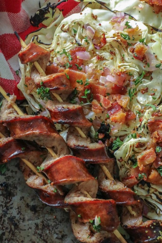 Char Grilled Cabbage Steaks and Smoked Sausage spiralized on a platter.