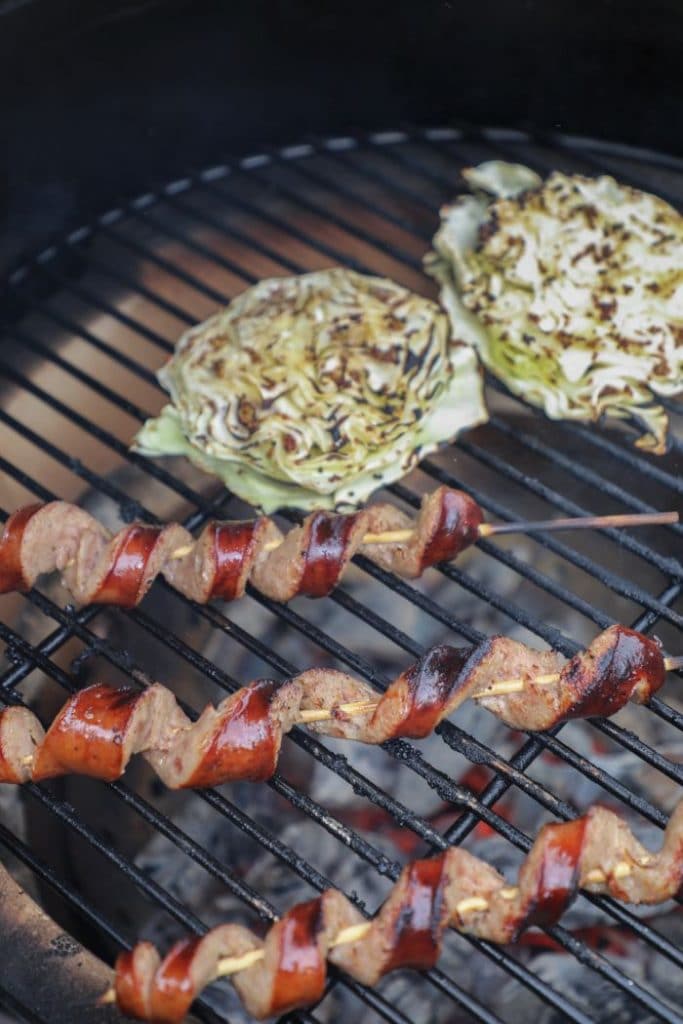 Smoked sausage on a stick over direct heat on the big green egg.