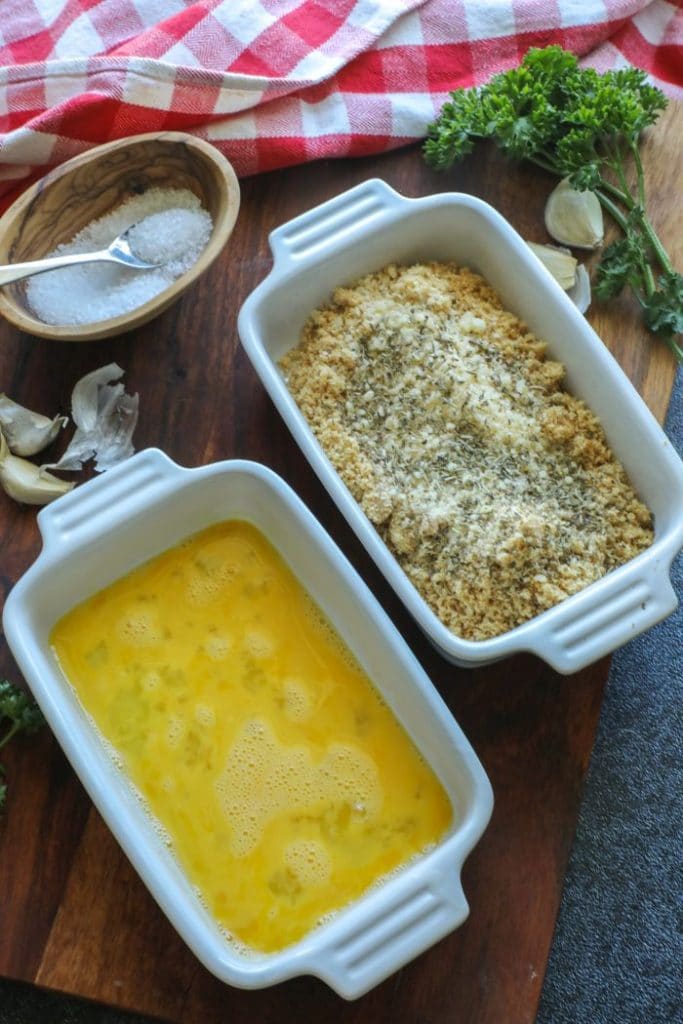 Two shallow dishes with the egg wash and pork rind crumbs.