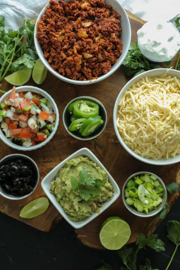 A platter of all the nacho toppings for the cauliflower gnocchi nachos