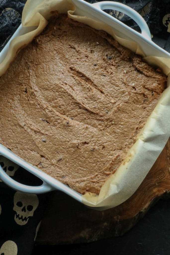 Batter for the Keto Chocolate Pumpkin Butter Brownies in an 9x9 inch pan