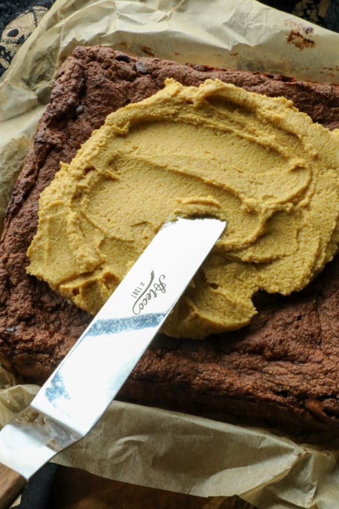 Frosting the keto chocolate pumpkin butter brownies
