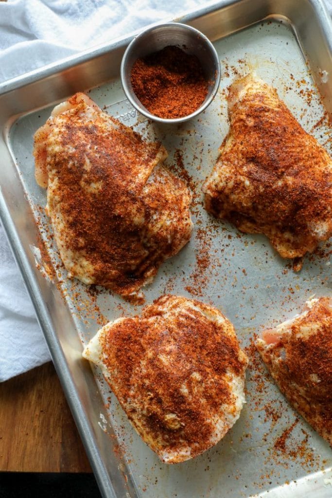 Grilled Crispy Maple Pecan BBQ Chicken Thighs prepped on a pan