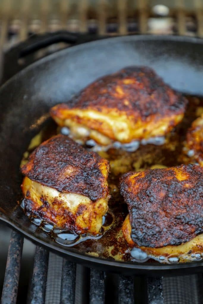 Grilled Crispy Maple Pecan BBQ Chicken thighs cooking on the grill