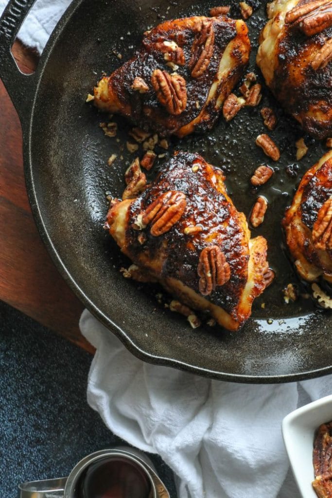Grilled Crispy Maple Pecan BBQ Chicken Thighs with maple syrup over them