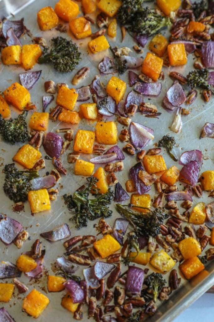 The roasted vegetables, cooked, on a baking sheet. 